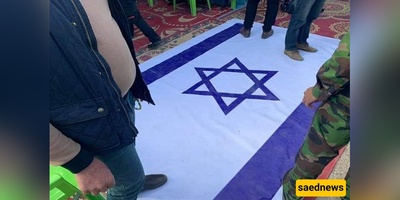 بصوره تثیر إعجاب الملایین: عندما سحق الإمام الخامنئی الکیان الصهیونی بخطوه واحده — صوره للعلم الإسرائیلی تحت قدم قائد الثوره تتصدر وسائل التواصل